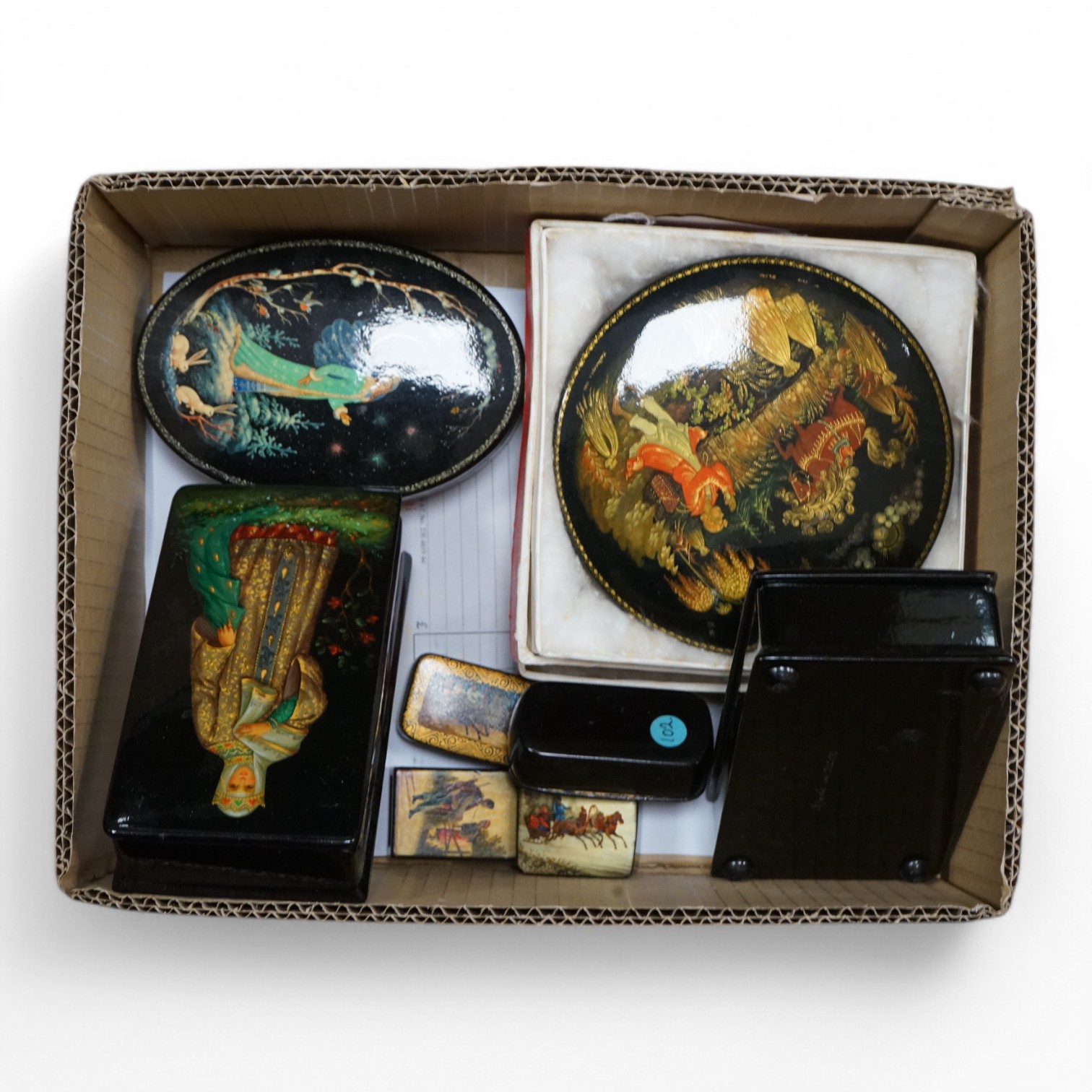 A quantity of mostly 20th century Russian lacquer boxes, a match striker and snuff boxes, some with original receipts. Condition - appears good